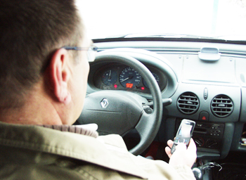 Conducteur écrivant un sms au volant.